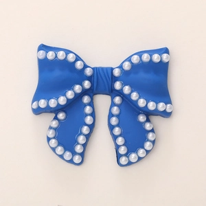 Deep blue resin bow accessory with white faux pearl edges for DIY jewelry and crafts