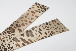 Detail of leopard print halter neck strap fabric showing soft texture and pattern detail