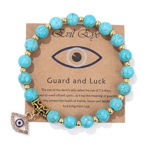 Detail view of Evil Eye beaded bracelet with matte blue stones on branded card