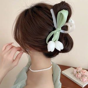 Elegant side view of a light green ribbon hair claw clip with white tulip floral design