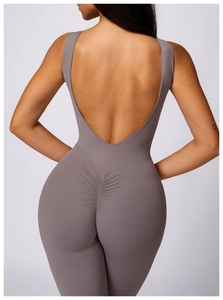 Deep taupe backless yoga bodysuit with ruched peach lifting detail and flared legs