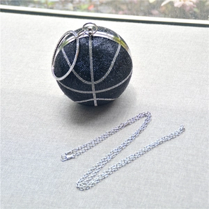 Macro detail of black basketball clutch bag with glittering rhinestones and silver handle
