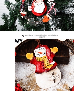 Close-up of a Christmas snowman ornament made of wood and iron on a festive wreath