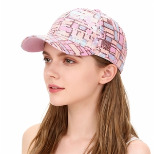 Close-up of pink sequin baseball cap showing intricate grid pattern and glitter texture