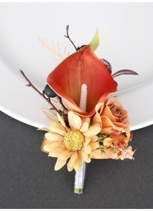 Detailed macro view of an orange calla lily boutonniere with satin wrapped stems