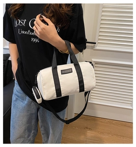 Detail of cream canvas Boston bag with black nylon strap and matching small coin purse
