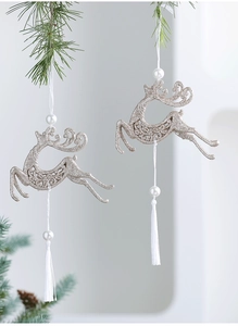 Detail of champagne gold reindeer Christmas ornaments with glitter pearls and white tassels
