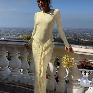 Elegant pale yellow knitted maxi dress with ruffled hem and slim fit for autumn style