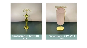Detail view of gold metal jewelry stands including a female figure and velvet oval rack