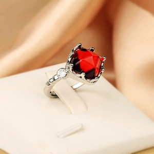 Luxurious silver open ring with large cushion-cut red gemstone and white diamond accents