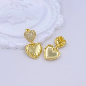 Detail view of golden heart earrings with pavé zircons and mirror polished finish