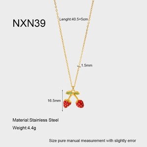 Detail of red enamel strawberry pendant on a gold stainless steel chain necklace