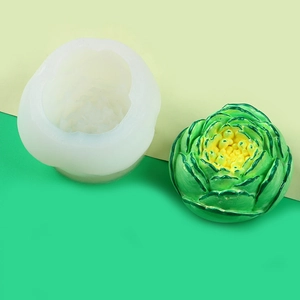 Detailed silicone mold and finished green cabbage shaped resin handicraft on beige background