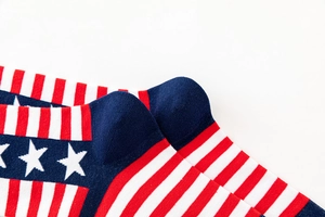 Detailed close-up of knitted cotton crew socks featuring an American flag pattern design