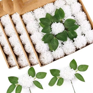 Detail view of white foam hydrangea heads with realistic green leaves in a kraft paper box