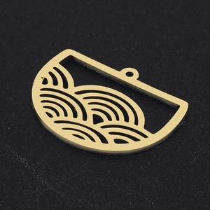 Close-up of golden semicircular hollow wave pattern pendant for DIY jewelry making