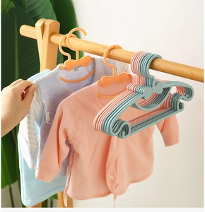Baby hangers in pink and blue with bow design and non-slip notches on wooden rod