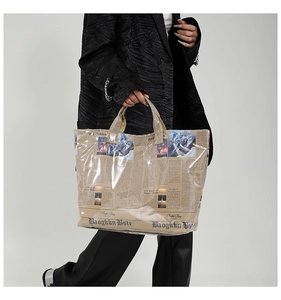 Detail of newspaper print tote bag with waterproof transparent PVC coating and woven handle