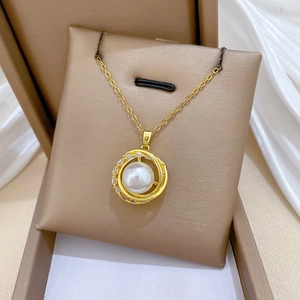 Detailed macro of bird nest necklace pendant with white pearl and sparkling crystals