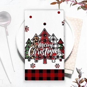 Detailed view of Christmas dish towel with festive tree patterns and Merry Christmas text