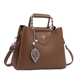 Brown lychee leather shoulder bag with chain handle and elegant leaf pearl pendant
