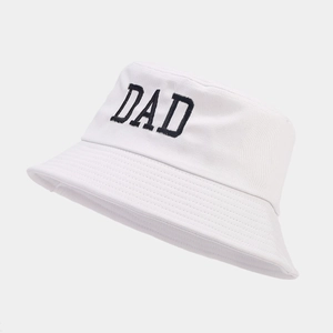 White cotton bucket hat with black DAD embroidery in a minimalist fashion style