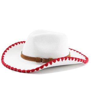 Detail of white cowboy hat with red braided edge trim and brown leather adjustable strap