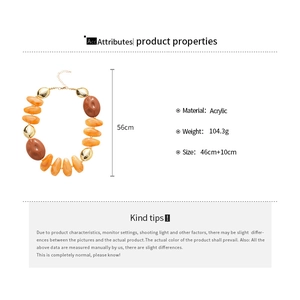 Detail view of chunky amber acrylic resin necklace with golden beads and size specifications