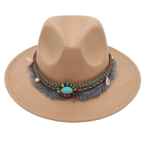 Close-up of camel felt hat with ethnic woven band, turquoise stone, and beaded tassels