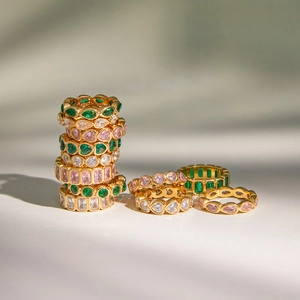 Classic gold rings featuring emerald and pink zircon gemstones in diverse elegant cuts