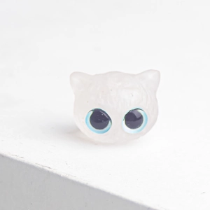 Close-up of pink crystal resin cat figurine with striking blue eyes and smooth finish
