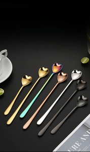 Detail of multi-colored heart-shaped long-handle stainless steel mixing spoons for coffee