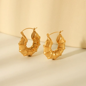 Chic hollow bamboo style gold hoop earrings in stainless steel with spiral design
