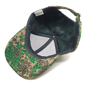 Macro detail of breathable mesh interior and adjustable strap on camo jacquard baseball cap