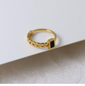 Detail of 18K gold-plated chain ring featuring a black rectangular enamel inlay design