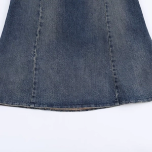 Close-up of dark blue denim midi dress showing hem stitching and washed texture