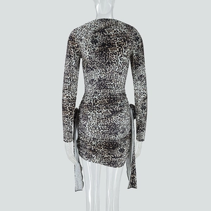 Detailed back view of a slim leopard print mini dress featuring side ruching and ribbon ties