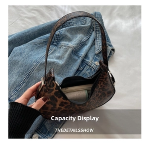 Internal view of leopard print crescent bag showing space for phone and wallet