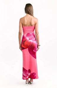 Detailed back view of a pink strapless long dress with large red floral prints and slim fit