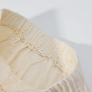 Detailed close-up of elastic waistband with soft pleats and smooth inner lining