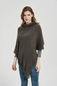 Close-up detail of coffee brown knit shawl with faux fur collar and asymmetric tassel hem