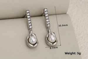 Detail view of silver earrings with crystals and pearl showing size 30.9mm by 8.7mm