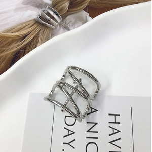 Detailed view of silver hollow hair cuff clip on blonde ponytail in natural light
