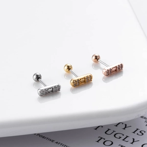 Detailed view of rectangular zircon stud earrings in silver, gold, and rose gold finishes