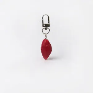 Realistic red sweet potato fruit keychain with silver metal lobster clasp on white background