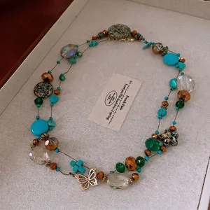 Bohemian layered beaded necklace with butterfly pendant and turquoise glass beads