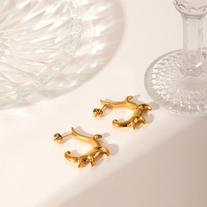 Detailed view of C-shape irregular flame earrings in 18K gold plated stainless steel