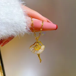 Detail of gold ballet dancer pendant necklace with shimmering cubic zirconia inlay