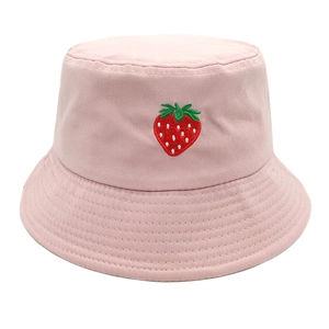 Detailed close-up of pink cotton bucket hat with vibrant strawberry embroidery on white background