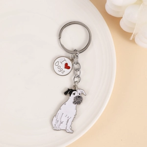 Detailed close-up of a metal dog keychain with I Love Dogs charm and Schnauzer pendant